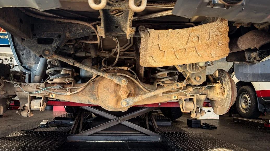 A vehicle raised on a workshop lift