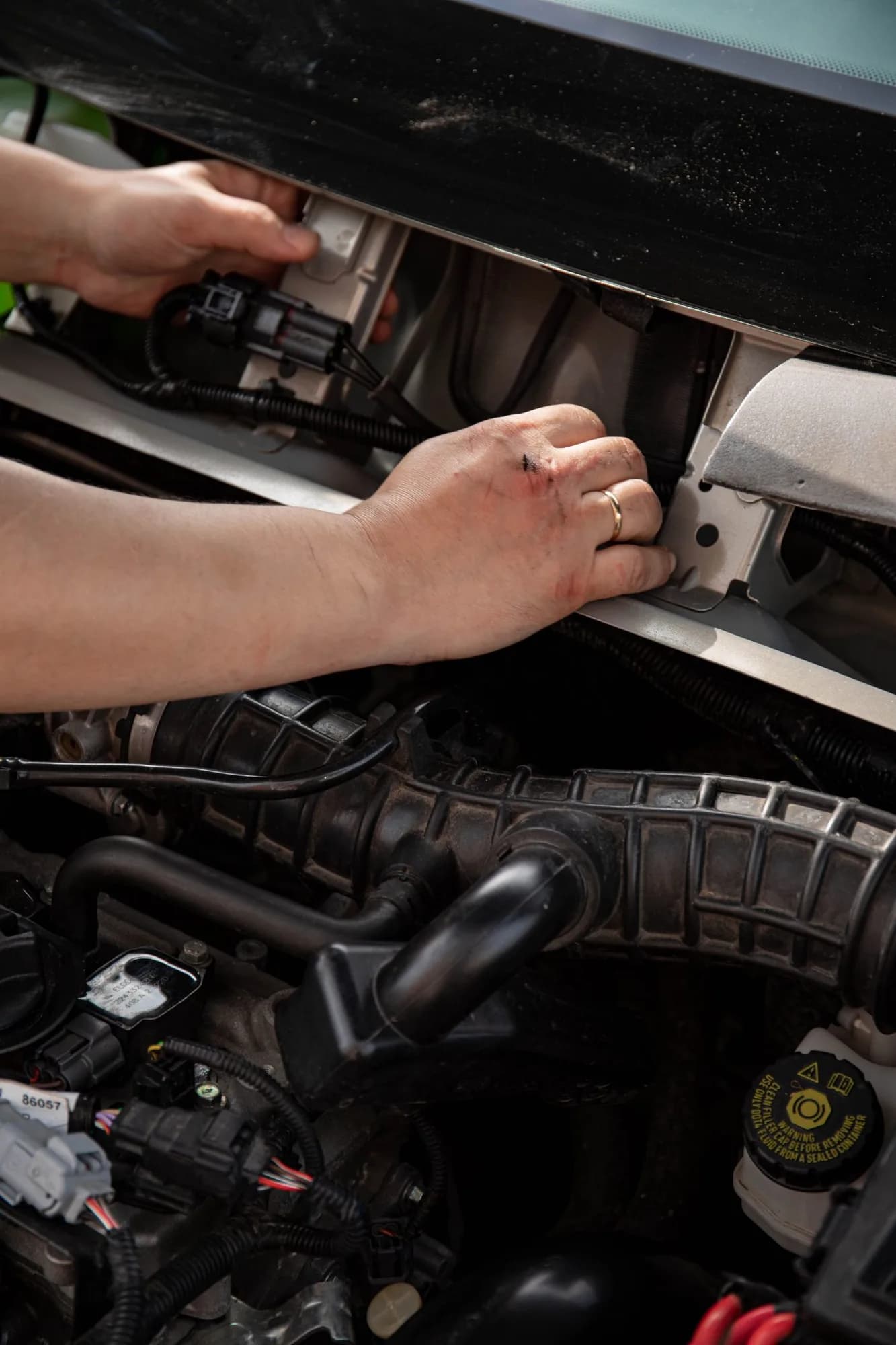 A technician working on a vehicle's wiring